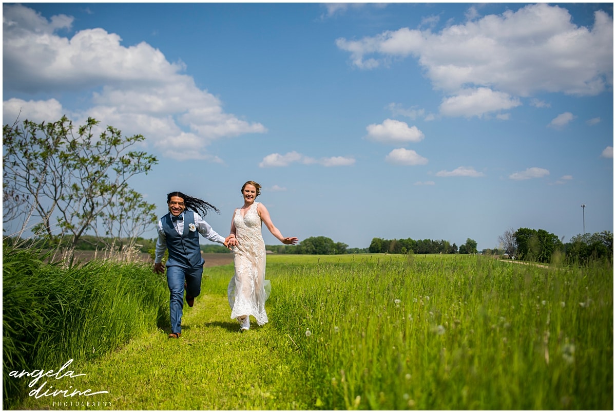 Rubies and Rust Wedding bride and groom running through field