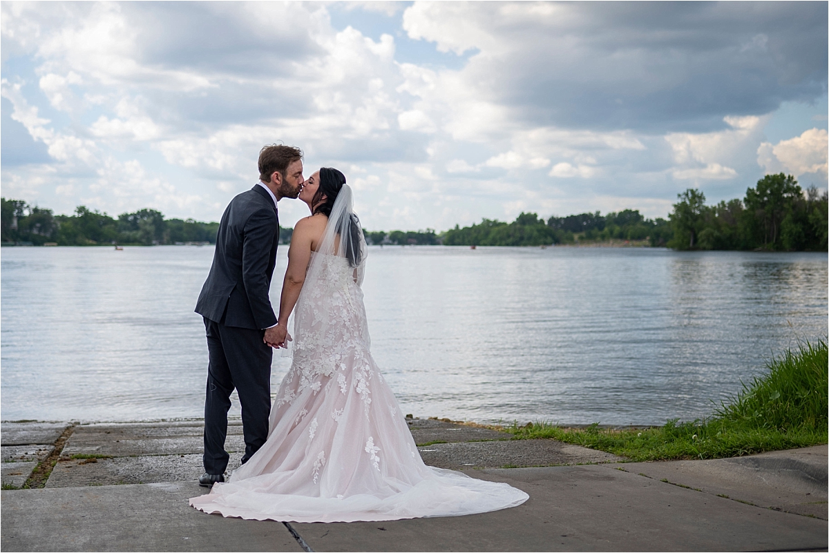 Camrose Hill Flower Farm Wedding bride and groom kissing by a lake