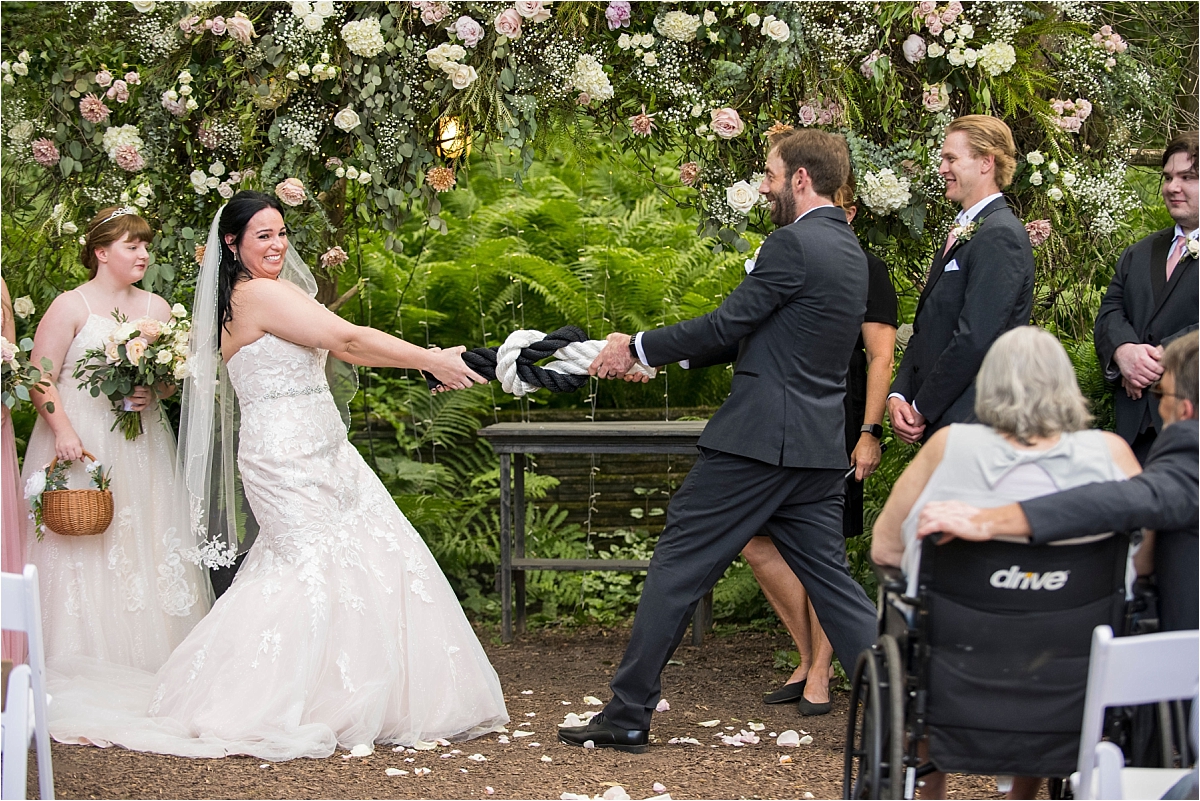 Camrose Hill Flower Farm Wedding bride and groom tugging on rope