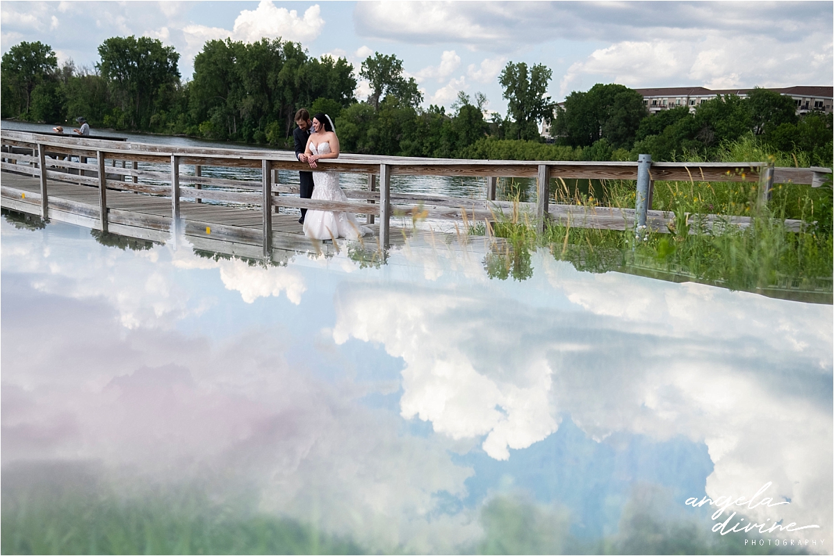 Camrose Hill Flower Farm Wedding bride and groom on bridge over lake