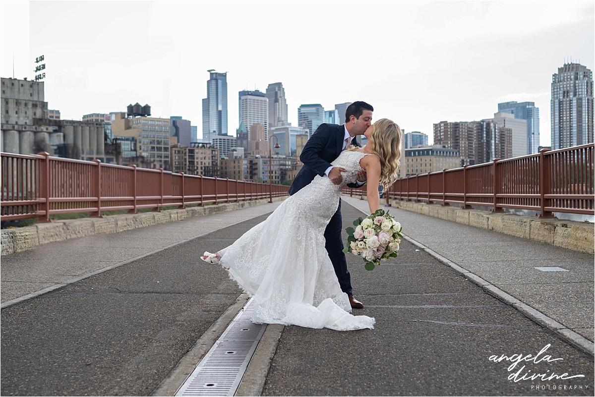 Minneapolis Event Centers Wedding bride and groom kissing on bridge